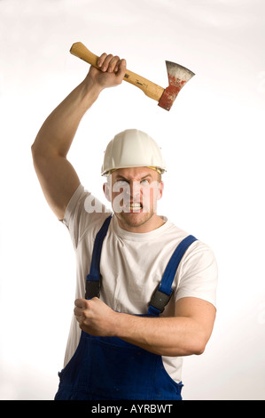 Construction worker wielding a hatchet Stock Photo