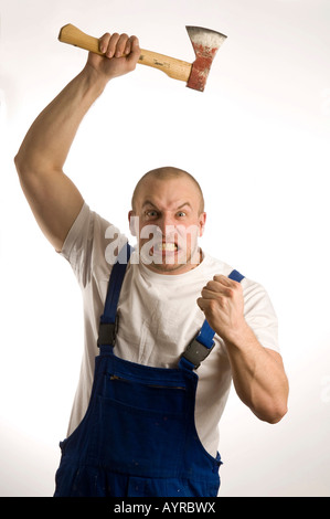 Construction worker wielding a hatchet Stock Photo