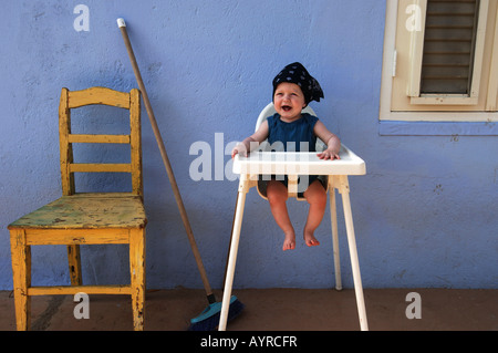 Netherlands Antilles Curacao a baby boy waiting for his food Stock Photo
