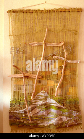 Three driftwood Crosses of Calvary on tapestry wall hanging. Minneapolis Minnesota USA Stock Photo