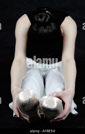 Young female ballet dancer, ballerina, stretching Stock Photo