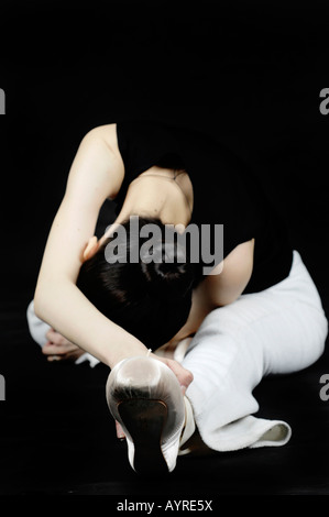 Young female ballet dancer, ballerina, stretching Stock Photo