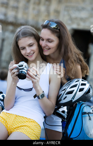two young beautiful woman are visiting paris in summer with bicycle Stock Photo