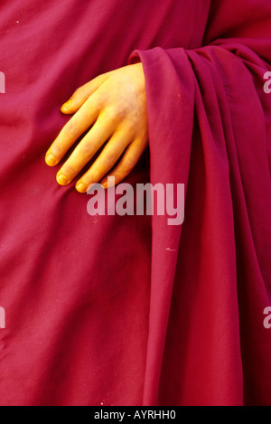 Details of a monk's hand tinted by yellow, Bhutan Stock Photo