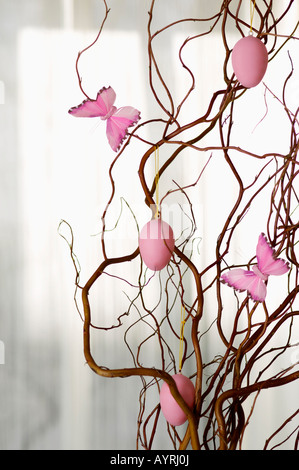Painted Easter eggs hanging on a branch, close-up, selective focus Stock Photo