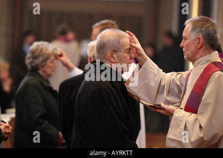 Pastor Johannes Stein ashing parishioners' foreheads on Ash Wednesday at the Herz-Jesu Church in Koblenz, Rhineland-Palatinate, Stock Photo