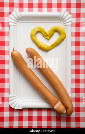 Two wieners with heart-shaped mustard Stock Photo