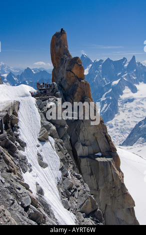 Mountain climber standing on a rock platform, Mt. Aiguille du Midi, Mont Blanc Massif, Chamonix, France Stock Photo