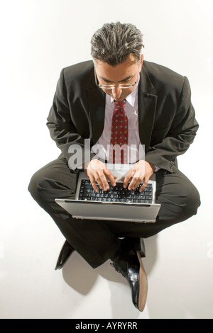 Businessman with a notebook on his lap Stock Photo