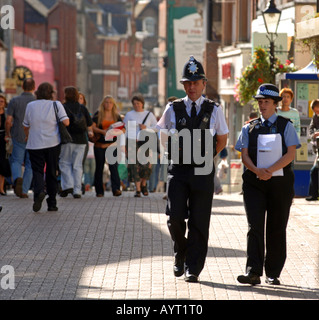 Police Officer and Special Constable or Community Support Officer on foot patrol in South Street, Dorchester, Dorset, Britain UK Stock Photo