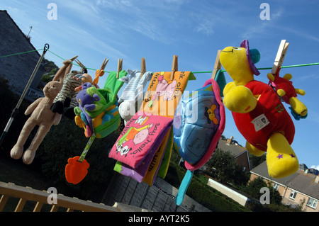 Soft toys drying on a washing line Stock Photo