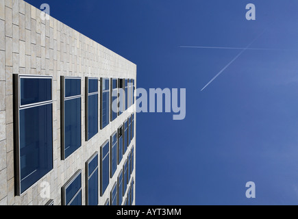 Airplane contrails in the sky over an office tower, Frankfurt, Hesse, Germany Stock Photo