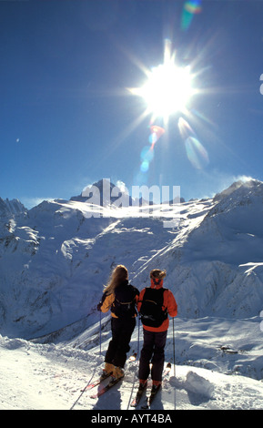 Two women on skis admiring the view of Mont Blanc Chamonix France Stock Photo