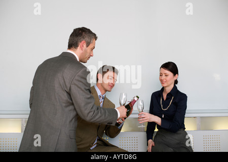 Three businesspeople drinking sparkling wine Stock Photo
