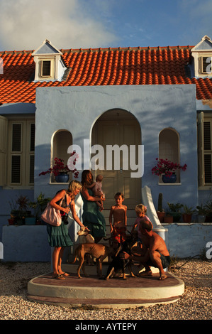 Netherlands Antilles Curacao expat family posing on the steps of their historical colonial Dutch cottage Stock Photo