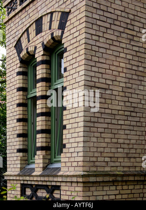 Red brick building with curved window decorations Stock Photo