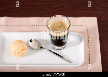 A glass of Coffee and a teaspoon Stock Photo