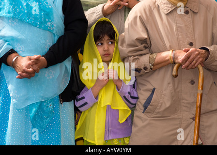 Sikh girl outside gurdwara or temple playing music on the festival of Vaisakhi Sri Guru Singh Sabha Hounslow Middlesex UK 2008 Stock Photo