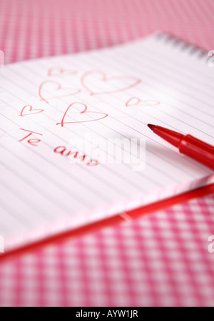 Te Amo hearts scribble on a pad with pen Stock Photo