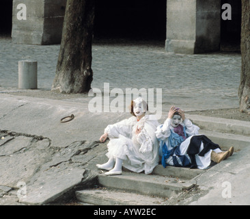 Carnival costumed people relaxing after the festivities of Mardi Gras. Stock Photo