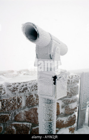 Frozen Telescope at the Upper Station and Ptarmigan Restaurant near the top of Cairngorm Mountain. Stock Photo