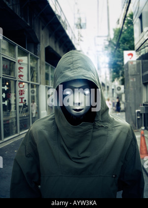 Robot wearing a hooded anorak walking down the high street Stock Photo