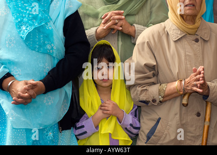 Sikh girl outside gurdwara or temple playing music on the festival of Vaisakhi Sri Guru Singh Sabha Hounslow UK 14 April 2008 Stock Photo