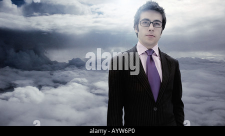 Suited business man with a cloudy sky background Stock Photo