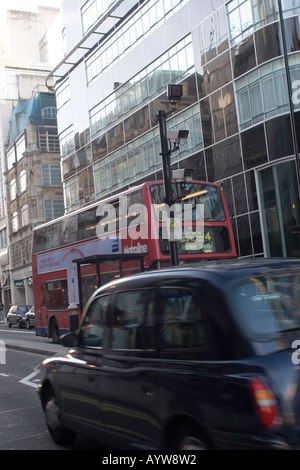 Security cameras in Fleet Street, black cab, red London bus and former Daily Express building Stock Photo