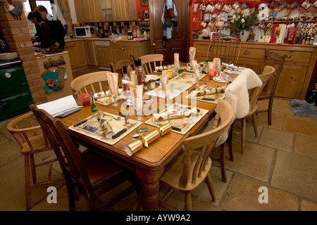 Table set for Christmas lunch farmhouse kitchen Cotswolds UK Stock Photo