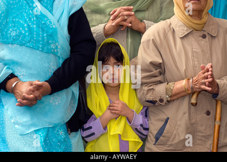 Sikh girl outside gurdwara or temple playing music on the festival of Vaisakhi Sri Guru Singh Sabha Hounslow Middlesex UK Stock Photo