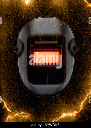 A welding mask surrounded by sparks Stock Photo