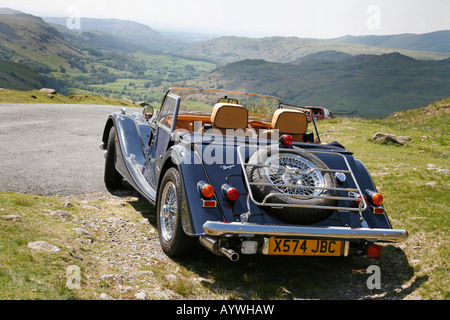 Morgan 4/4 2 seater Sports Car at the summit of Hardknott Pass, overlooking Eskdale. English Lake District Stock Photo