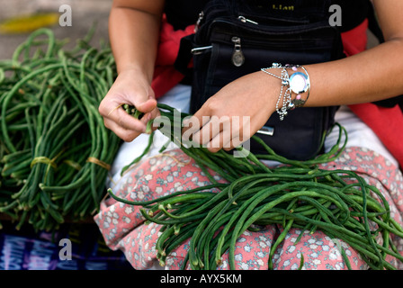 fiji suva girl stringing beans in the market Stock Photo