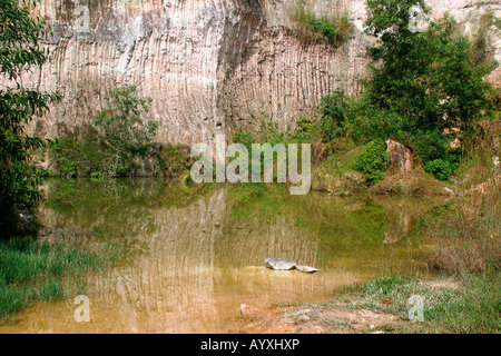 Reflections on the water - cliff-face reflected on the surface of a quarry pool Stock Photo