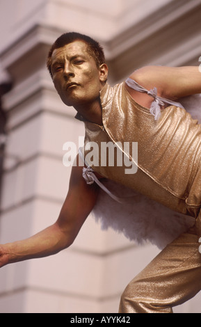 Living statue: Bronze coloured mime street entertainer posing as an angel in Covent Garden, London, England, Great Britain Stock Photo