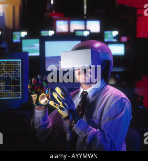 Virtual reality software and hardware development lab with program engineer wearing virtual reality display hood. Stock Photo
