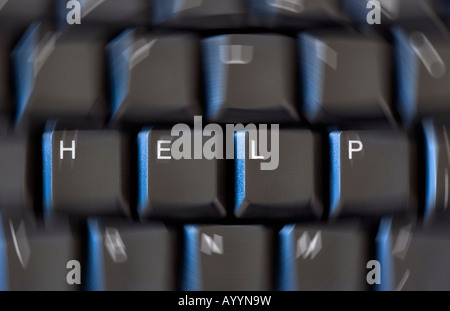 Keys on a computer keyboard forming the word 'HELP' with the rest of the keys blurred out to create a sense of urgency. Stock Photo