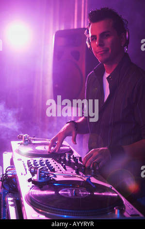 Hispanic dj playing at nightclub Stock Photo