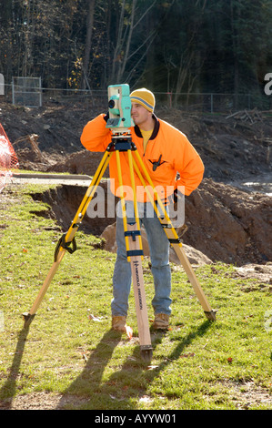 Surveyor at construction site making measurements Stock Photo