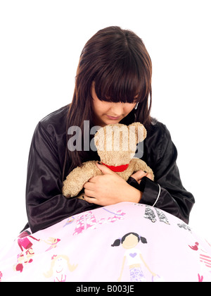 Young Fragile Teenage Woman Or Girl Holding A Comfort Teddy Bear To Feel More Secure In Life Stock Photo