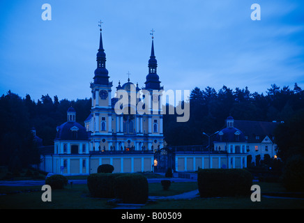 Baroque Pilgrimage Church in Swieta Lipka (Holy Lime) in masuria - blue hour. Next to the twin towers is the pilgrims shelter. Stock Photo