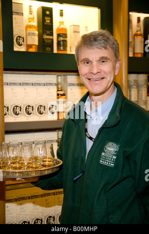 Scottish Whisky Industry   Man holding tray of whisky samplers at Oban Distillery Stock Photo