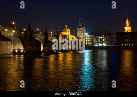 An evening view across the Vltava river of the Charles bridge and Old Town in Prague.