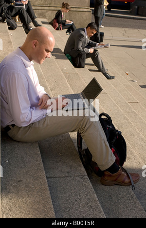 Man using Laptop Computer - City of London Stock Photo