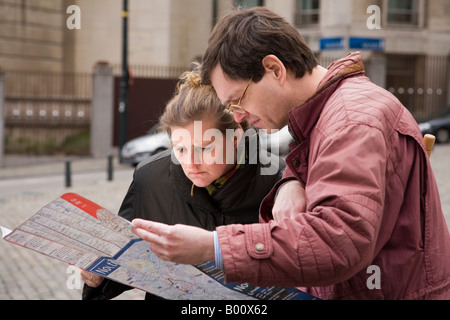 Tourist couple look at street map in Brussels, Belgium Stock Photo