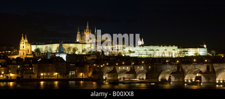 A 2 picture panoramic stitch night view of St Vitus's Cathedral within Prague Castle and the Charles Bridge in the foreground. Stock Photo