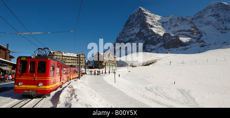Jungfraujock train at Kleiner Scheideg  in front of the North Face of The Eiger - Bernese Swiss Alps Stock Photo