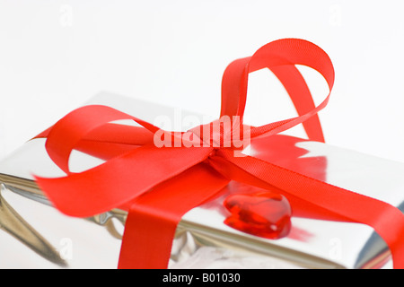 Colorful gift wrapping bows and silver sequins on white festive background.  Holiday copy space. Pull bow & ribbon, Top view Stock Photo - Alamy