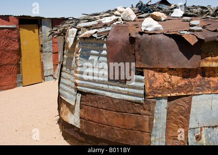 Namibia, Namib Desert, Spitzkoppe. Huts made out of cast off corregated iron sheets in a Damara farming community. Stock Photo